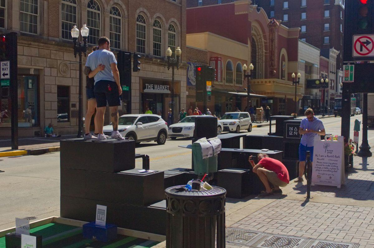 Two people pose together on the popup playground during Park(ing) Day on Sept. 21, 2018 in downtown Knoxville.