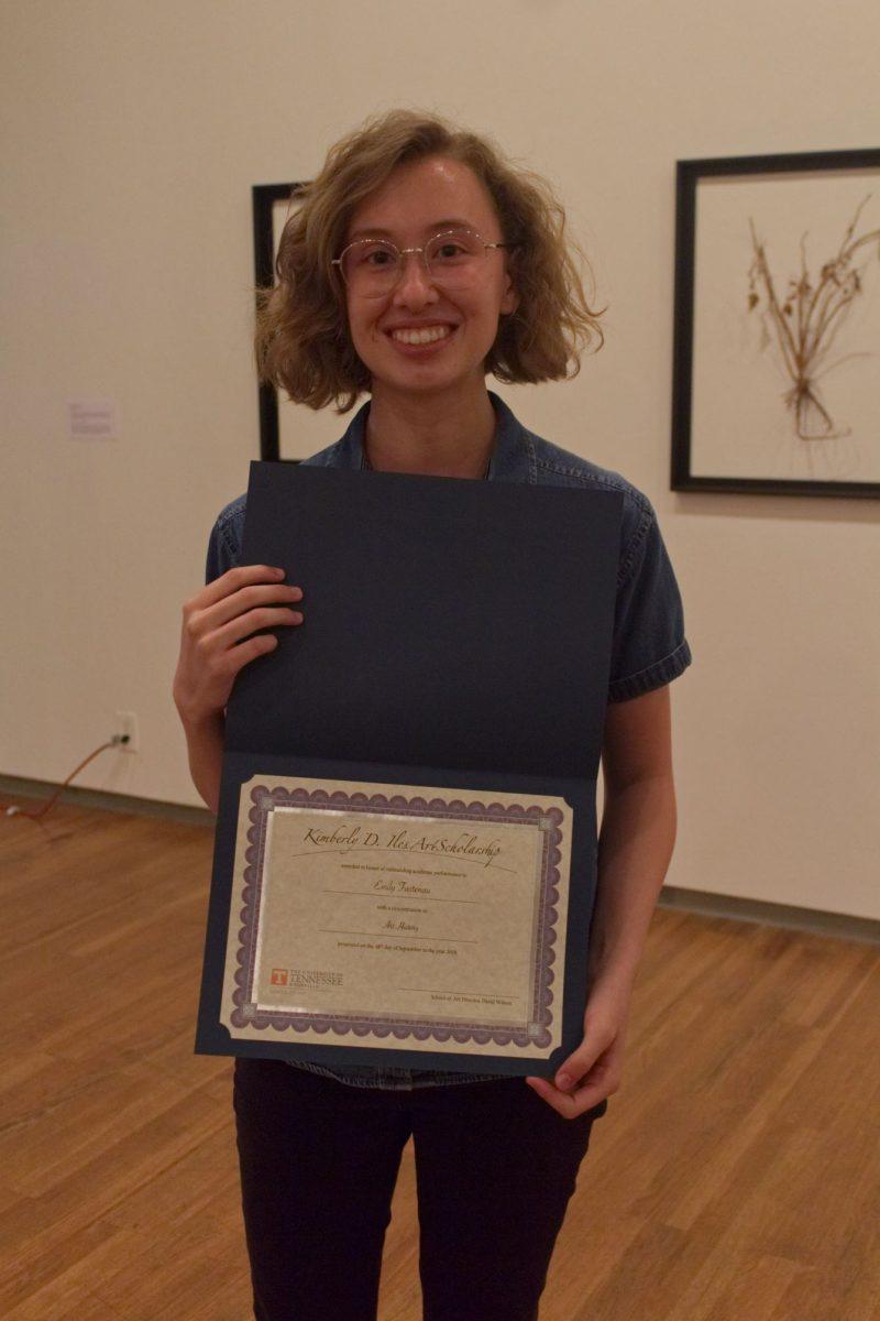 Senior in art history Emily Fastenau poses with her Kimberly D. Iles Art Award.