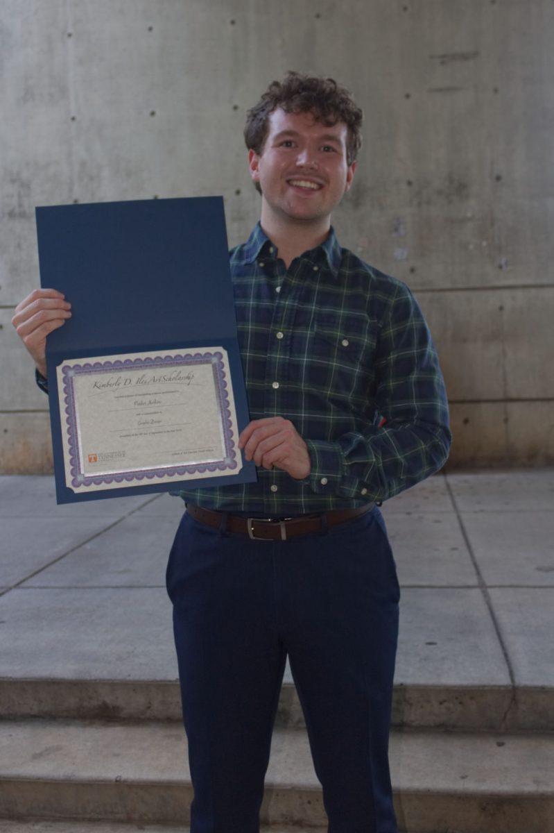 Senior in graphic design Robert "Parker" Jenkins poses with his Kimberly D. Iles Art Award.
