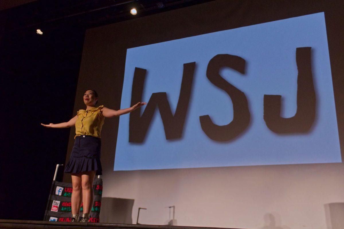Kristina Wong poses in front of the logo for her "Wong Street Journal" show on Sept. 11, 2018.