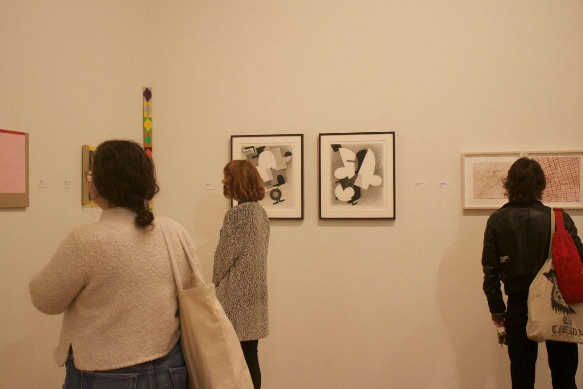 Students attend the opening night of the Blurring Boundaries exhibit in the Ewing Gllery in the Art and Architecture Building on Nov. 15, 2018. 