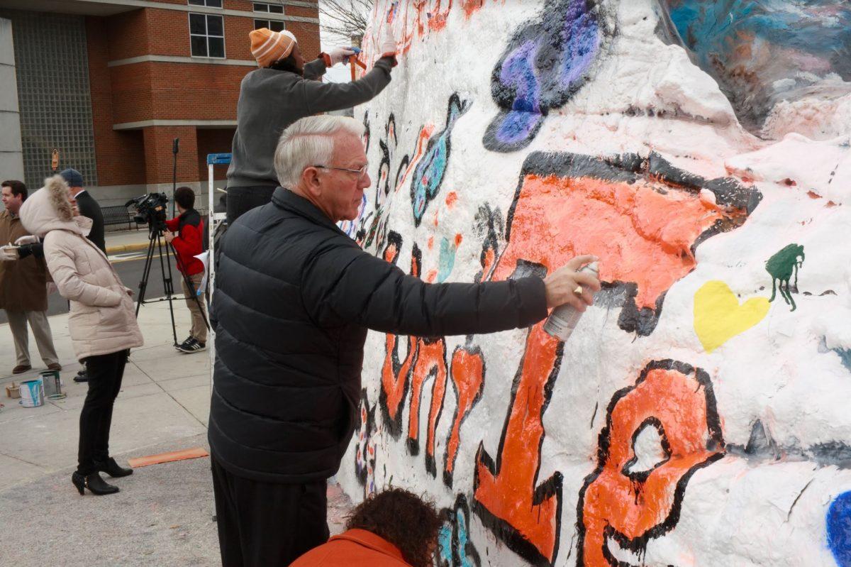 Chancellor Wayne Davis paints the rock on Dec. 5, 2018. 