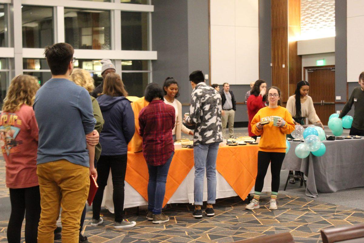 Students enjoy refreshments at a performance of spoken word poetry by Rudy Francisco. 