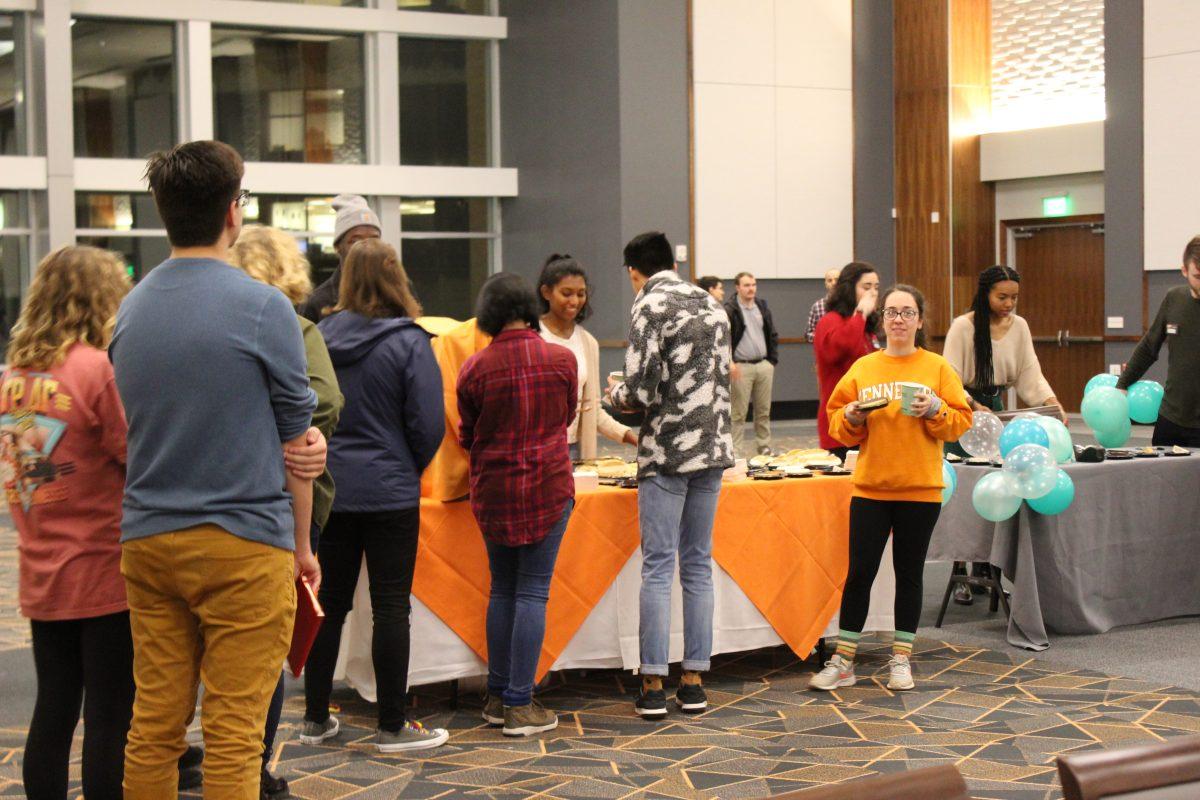Students enjoy refreshments at a performance of spoken word poetry by Rudy Francisco. 