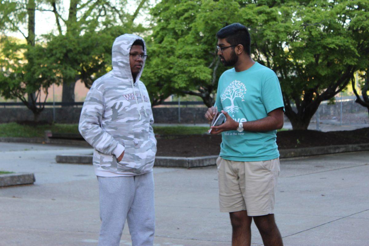 A Thrive campaign member speaks to a student in McClung Plaza on Monday April 15, 2019.