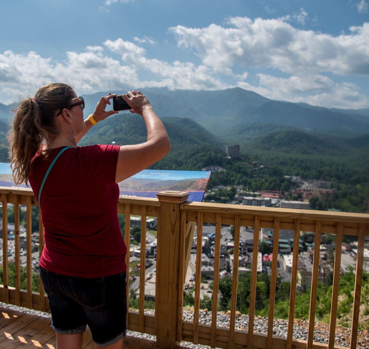 Ruby Red, a SkyBridge visitor from Seattle, WA, takes a photo of the view of Gatlinburg from the newly opened "SkyBridge," on Tuesday, May 28, 2019.