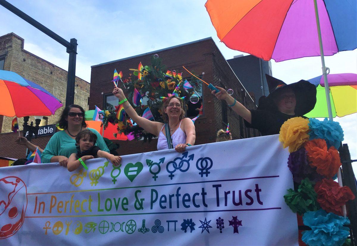 A float sporting all things colorful, from a flag bouquet to a rainbow banner. 