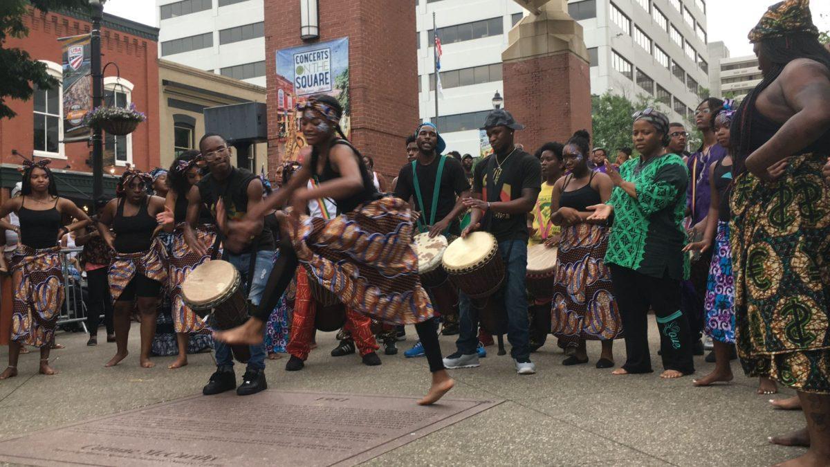 A single dancer from the Watoto troupe performs stepping quickly to the fast-paced rhythm of the drum. 