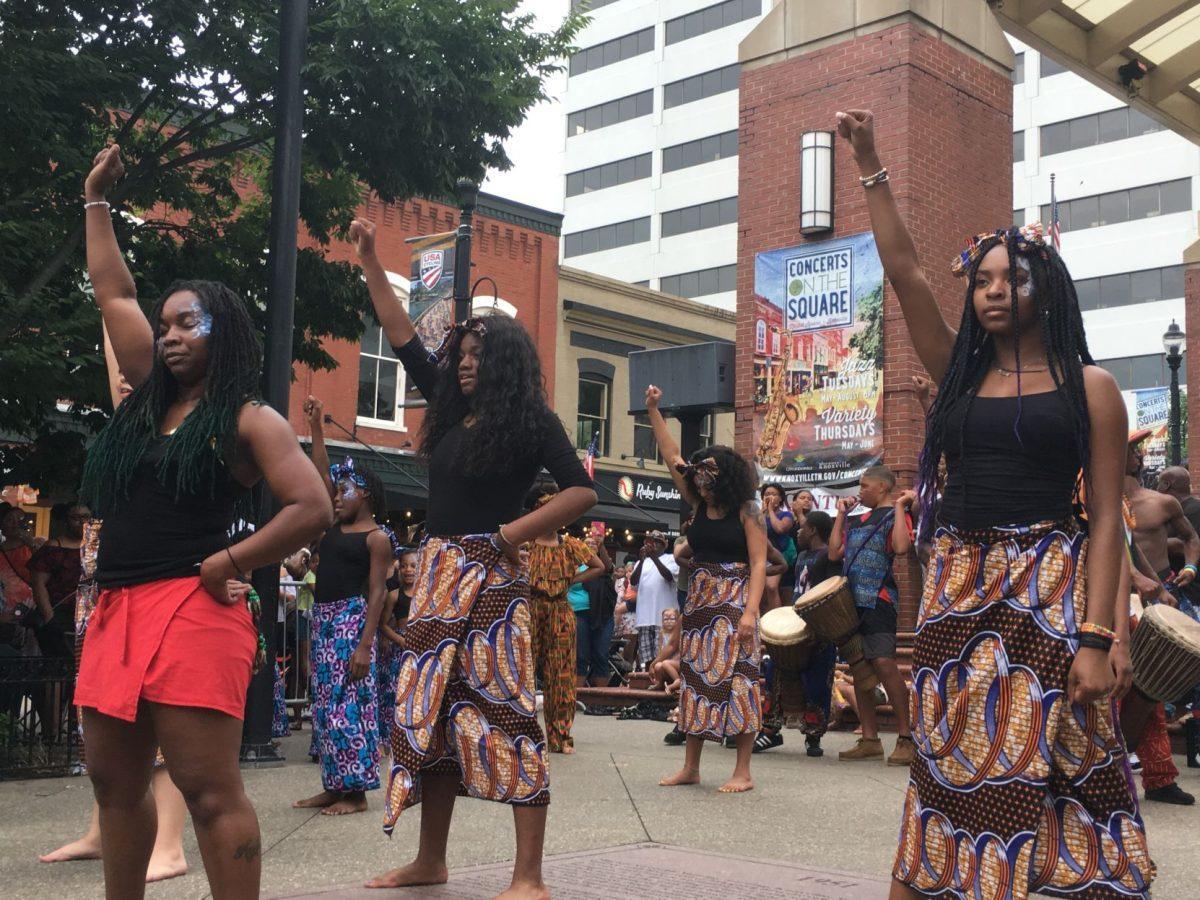 Standing with fists raised - symbolizing unity - marks the end of one of Watoto's performances. 