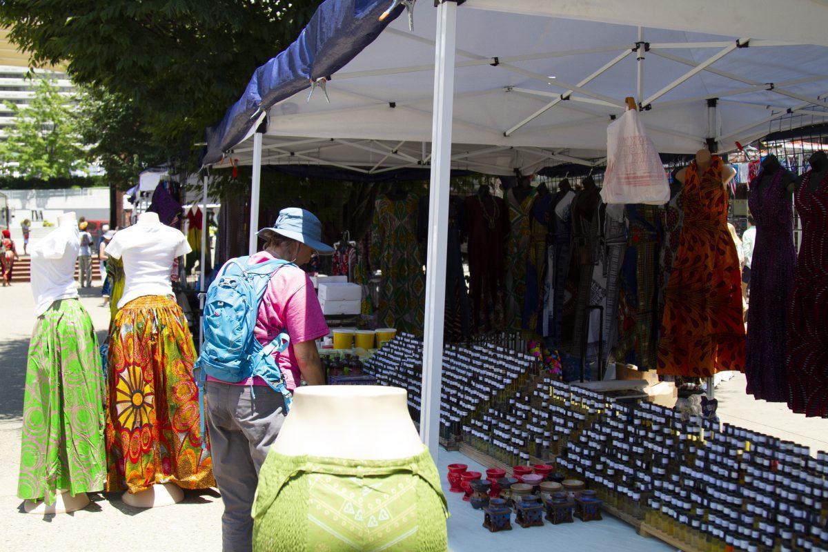 A customer browses Hajie Njaie's wares, which include two types of African Black soap, a large assortment of skin oils, pure shea butter and clothing.