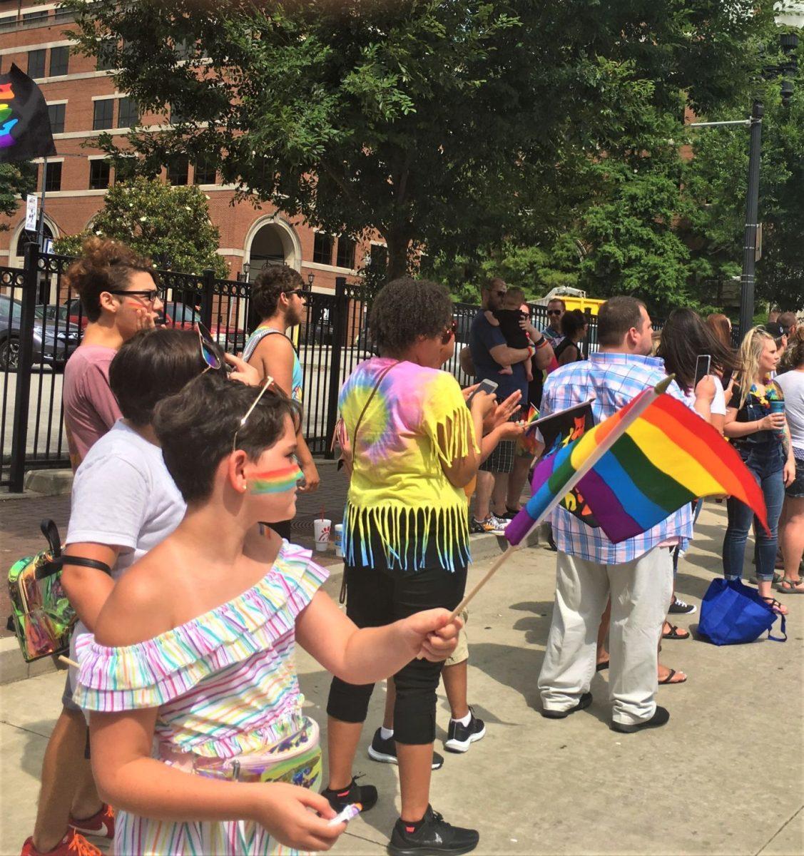 Entire families have come to the parade, with children waving flags and wearing rainbows on their cheeks. 