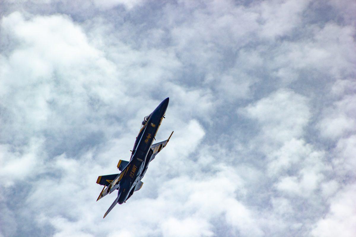 Blue Angels plane 4 performing a manuever during practice in Fort Pickens, Florida - June 26, 2019.