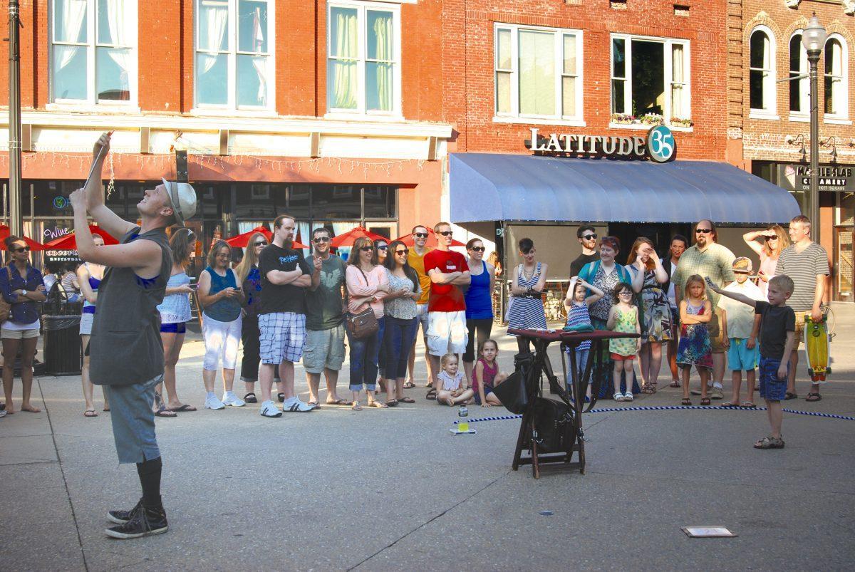 Harley Chapeau performs magic for visitors in Market Square.