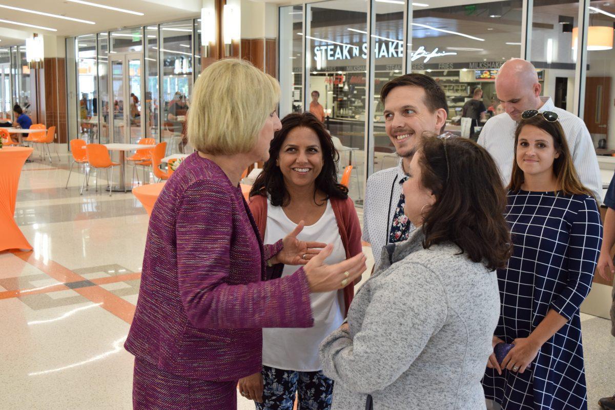 Chancellor Donde Plowman speaks briefly with Alternative Media Specialist Urmila Pandey, Testing Specialist John Newman and Testing Specialist Kelly Wakefield from Disability Services at her reception on the first floor of the Student Union during the first day of classes, Wednesday, Aug. 21.