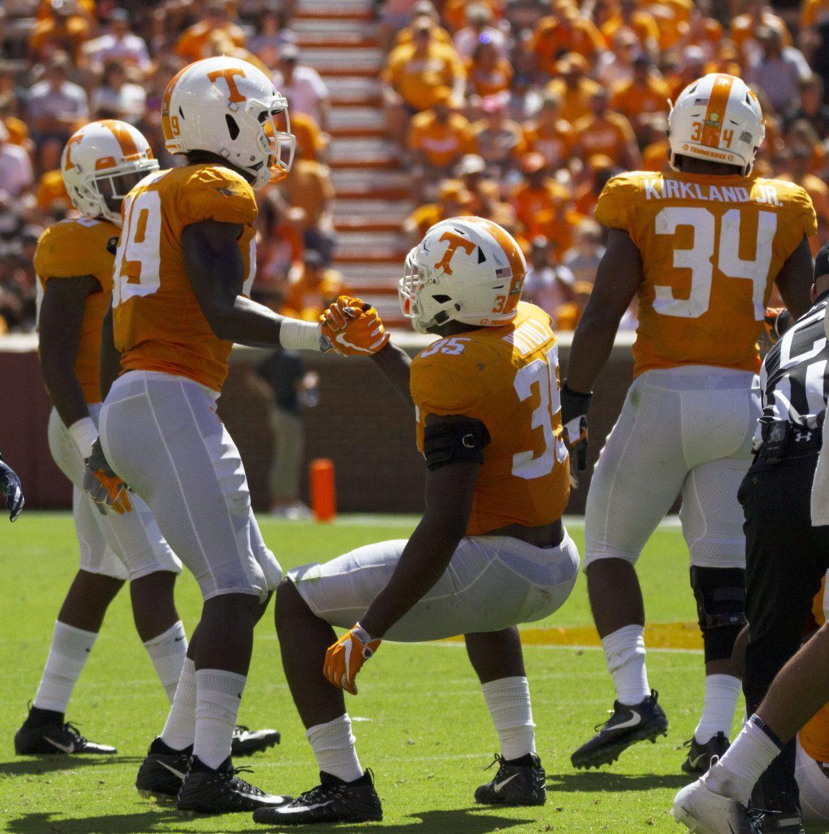 Jonathan Kongbo, # 99, helps Daniel Bituli, #35, h during game against UTEP on Sept. 15 2018 at Neyland Stadium.