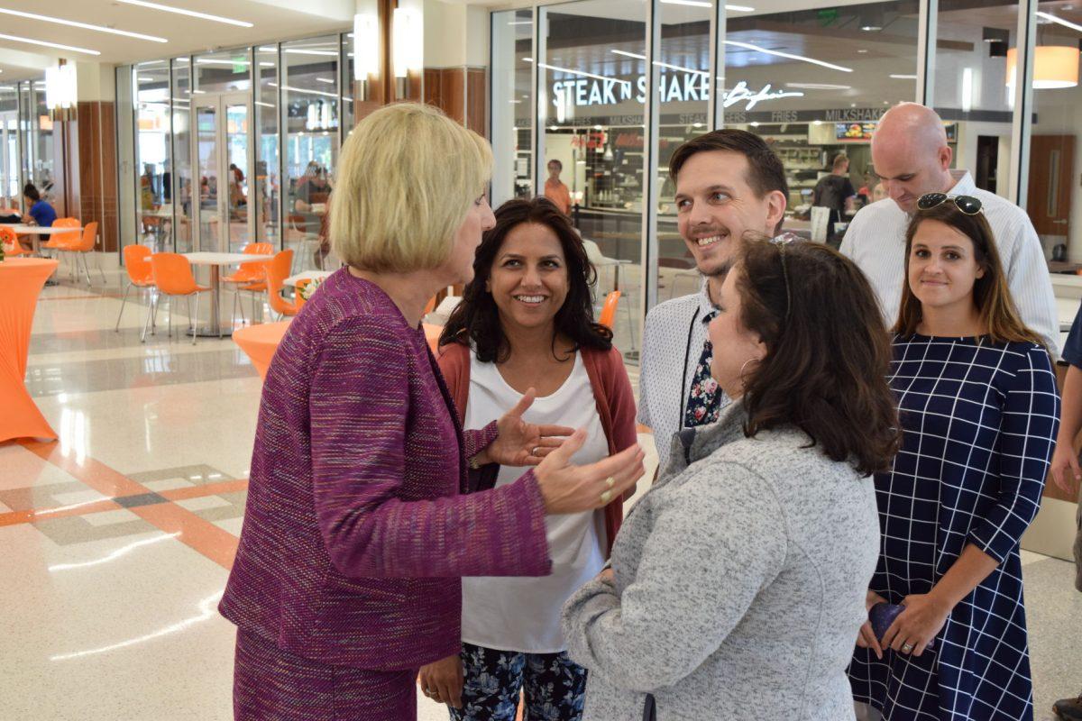 Chancellor Donde Plowman speaks briefly with Alternative Media Specialist Urmila Pandey, Testing Specialist John Newman and Testing Specialist Kelly Wakefield from Disability Services at her reception on the first floor of the Student Union during the first day of classes, Wednesday, Aug. 21.