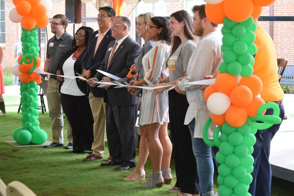 The ceremony on Friday, Aug. 23 for Magnolia and Dogwood Halls concluded with several university housing faculty members triumphantly cutting the ribbon, including (from left to right) West Campus Housing staff Brendan Miller, Executive Director of Student Housing Chandra Myrick, Vice Chancellor for the Division of Student Life Frank Cuevas, Vice Chancellor of Student Life Vincent Carilli, Chancellor Donde Plowman, senior in the interdisciplinary program Jasmine Wilcox, West Campus Housing staff Ruth Ann Reason, Ethan Johnson and University Housing Administration Steve Syoen.
