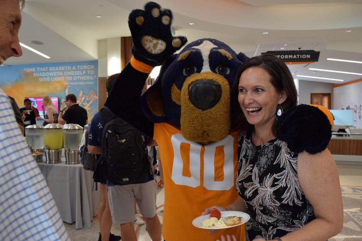 Smokey hugs Associate Professor and Director of the College of Social Work Lisa Reyes Mason during a welcome reception for Chancellor Donde Plowman on the first day of classes, Wednesday Aug. 21.
