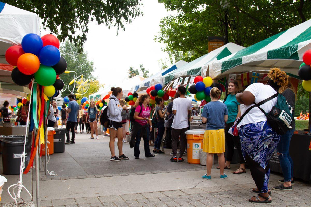 Students and community members attend various booths from different campus organizations at the International Festival on Ped Walkway on Friday, September 27, 2019.