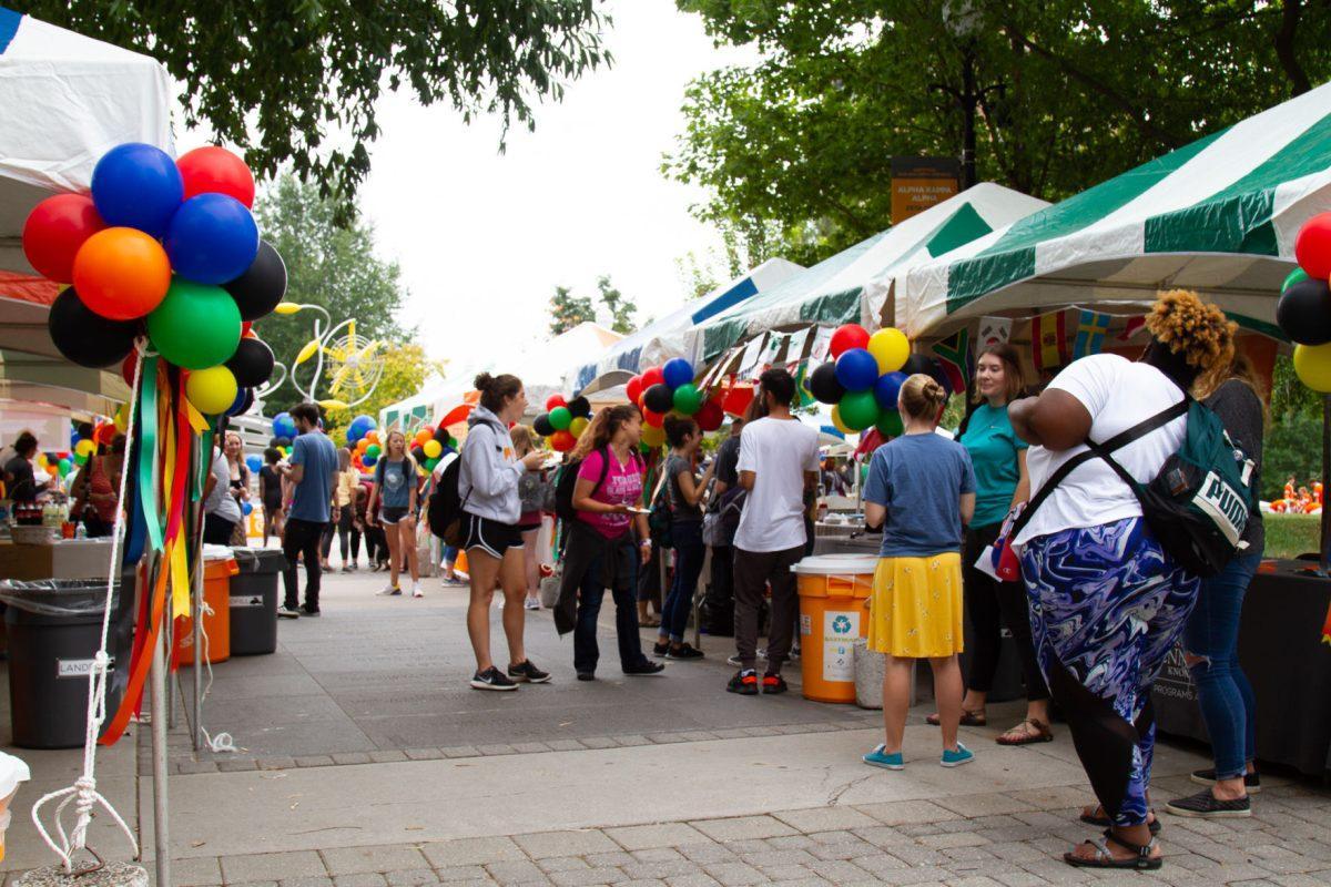 Students and community members attend various booths from different campus organizations at the International Festival on Ped Walkway on Friday, September 27, 2019.