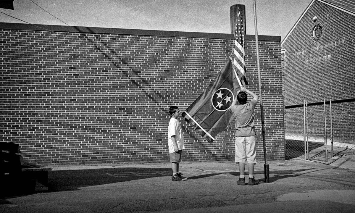 1997: Two boys raise an American flag outside their school in LaFollette.