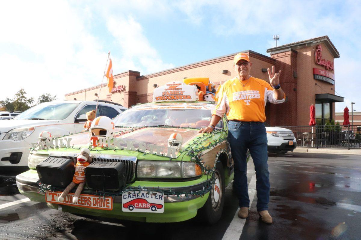 Coach Dave Moore shows off his famous Truckster, a game day vehicle designed to offer opposing teams' fans rides around the university in the name of hospitality.