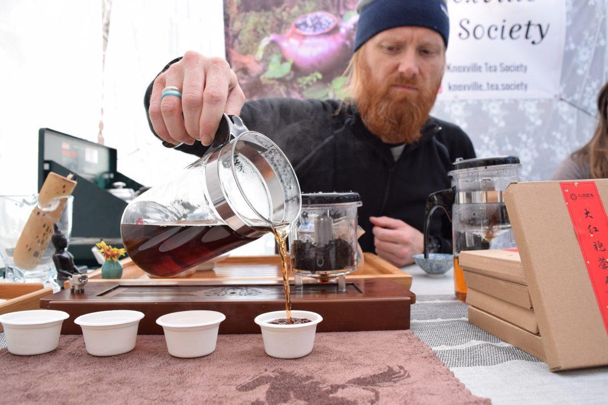 Andrew McCoy prepares tea samples at the Knoxville Tea Society booth during the Old City Market on Jackson Avenue on Saturday, November 9, 2019.