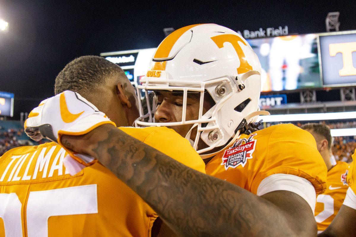 #1 Marquez Callaway hugs #85 Cedric Tillman after the victory at the 2020 Tax Slayer Bowl game.