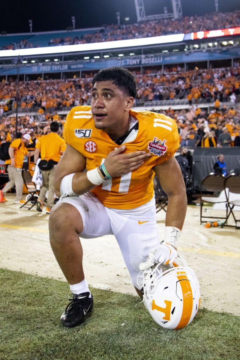#11 Henry To'o To'o pats his chest after the victory at the 2020 Tax Slayer Bowl game.