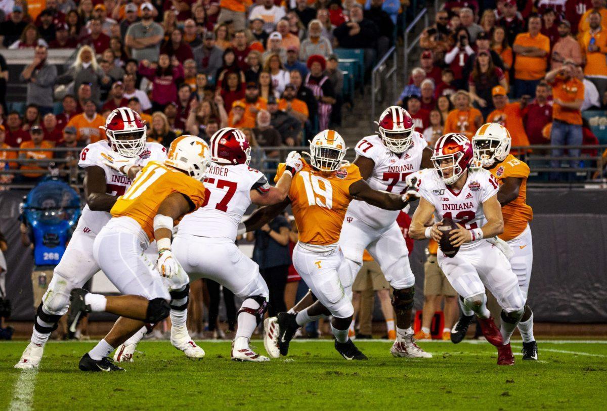 Tennessee volunteers close in around the Indiana quarterback in the 2020 Tax Slayer Bowl.