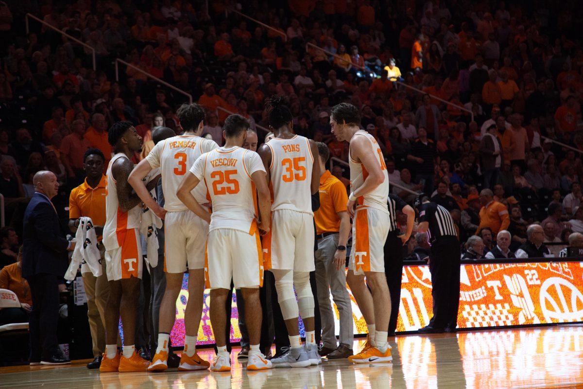 The Tennessee Men's Basketball team huddle around Coach Rick Barnes during a time out during the game against South Carolina on Saturday, January 11, 2020 at Thompson-Boling Arena.