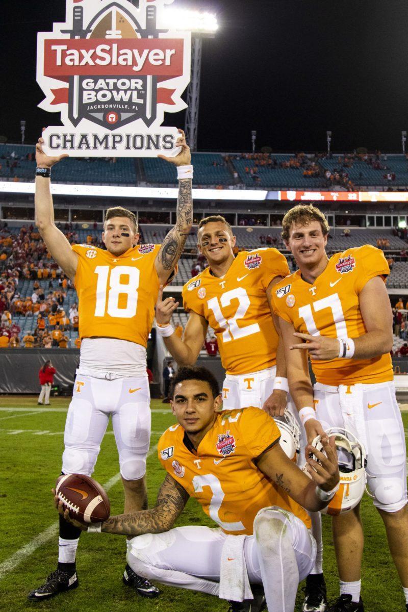 Volunteers celebrate after the victory at the 2020 Tax Slayer Bowl game.