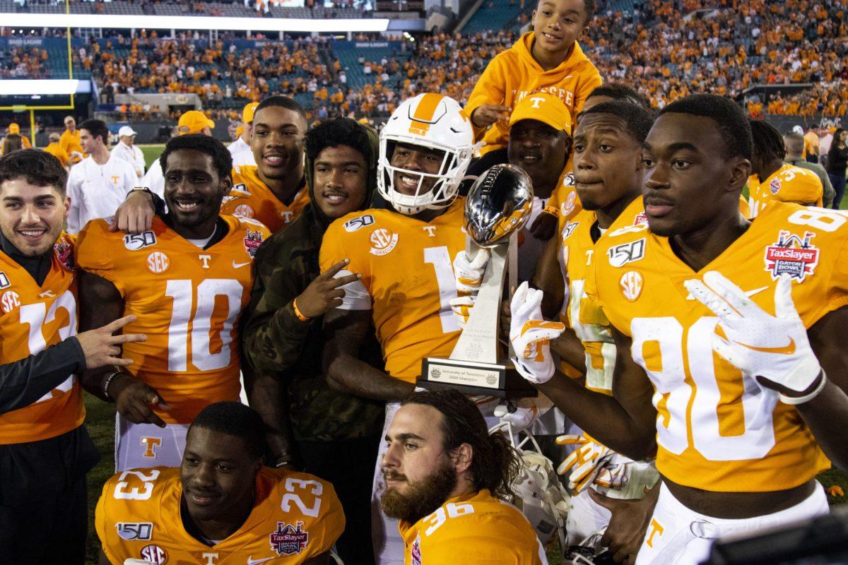 Volunteers showing off the trophy after the victory at the 2020 Tax Slayer Bowl game.