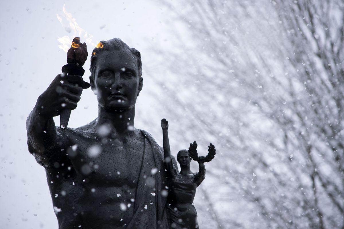 The Torchbearer surrounded by flurries of snow.