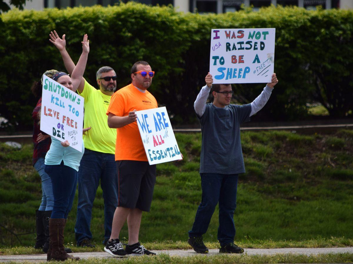 Protesters wave and hold signs along side Kingston Pike next to the closed West Town Mall during the Freedom Rally held on Sunday, April 19, 2020. The protest, one of seven across Tennessee, was to protest Governor Bill Lee’s stay-at-home orders and the closure of many local businesses.
