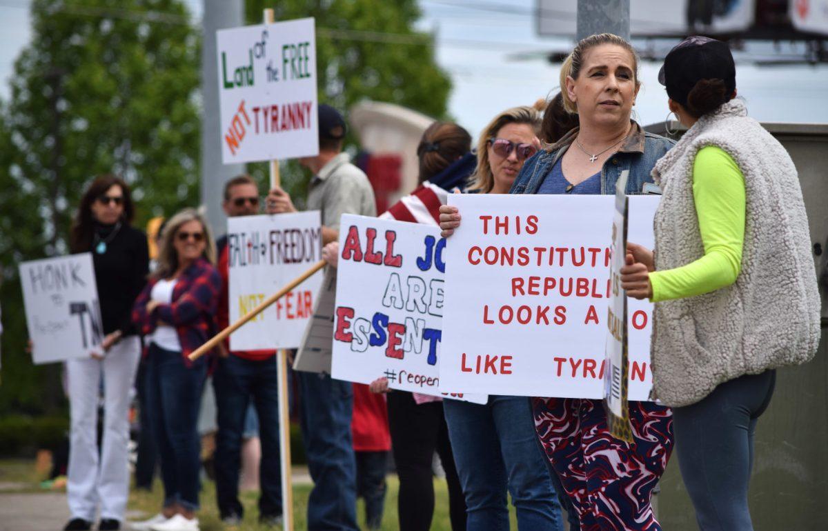 Protesters wave and hold signs along side Kingston Pike outside of the closed West Town Mall during the Freedom Rally held on Sunday, April 19, 2020. The protest, one of seven across Tennessee, was to protest Governor Bill Lee’s stay-at-home orders and the closure of many local businesses with his mandatory shutdown of nonessential businesses.