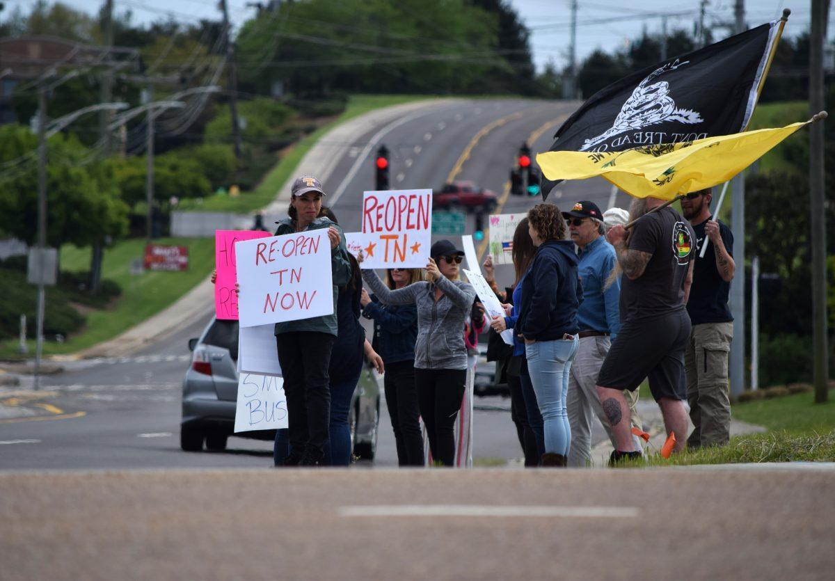 Protesters wave and hold signs at the corner of Morrell Road and Kingston Pike next to the closed West Town Mall during the Freedom Rally held on Sunday, April 19, 2020. The protest, one of seven across Tennessee, was to protest Governor Bill Lee’s stay-at-home orders and the closure of many local businesses.