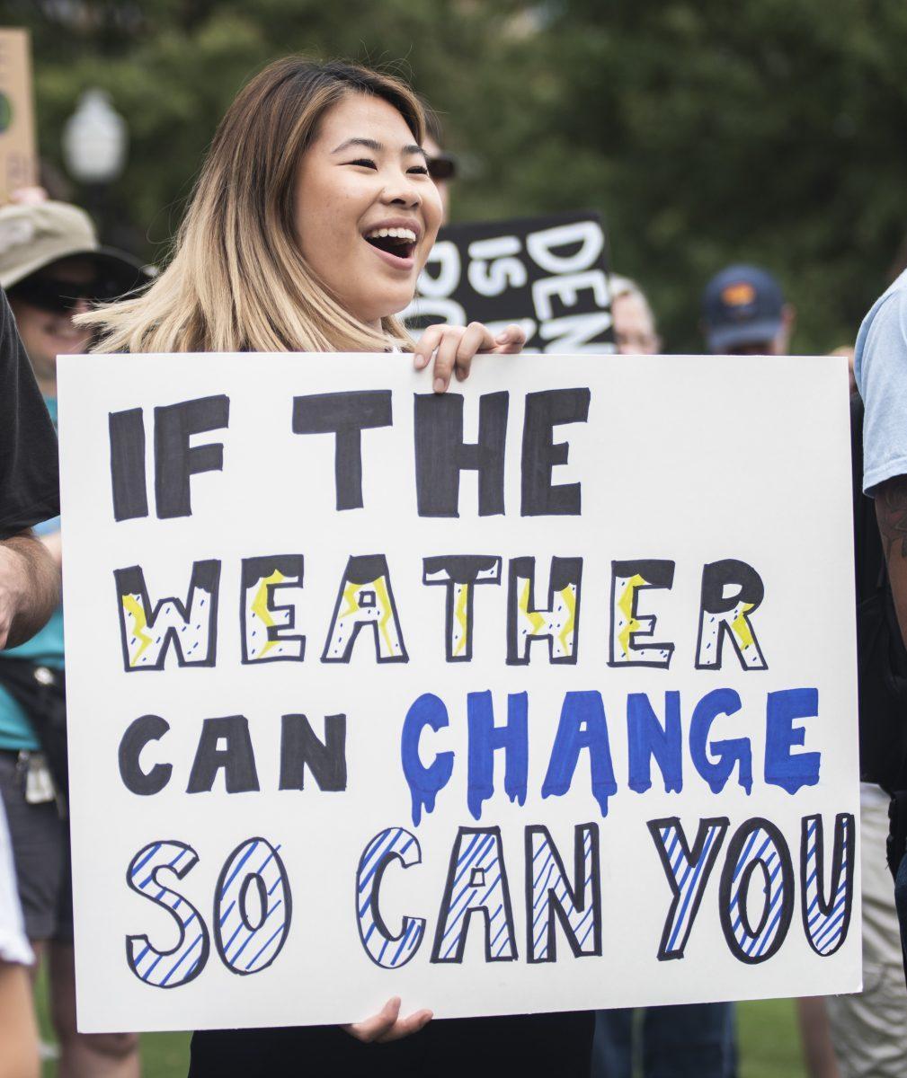 Maya Bian, a senior Global Health Equity student, holds a protest sign at the rally before the "Global Climate Strike" march, on Friday, September 20, 2019. 