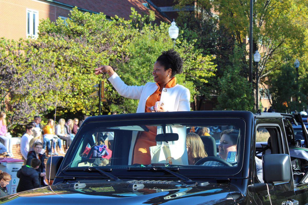 Dean Shea Kidd Houze hands out sunglasses to community members during the Homecoming Parade on Friday, November 1, 2019.