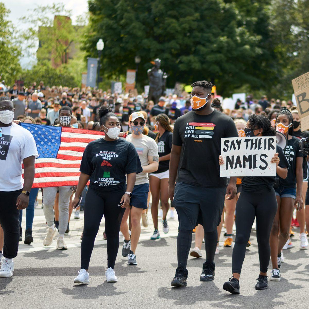A crowd of supporters march down Volunteer Boulevard during the BLM March on August 29, 2020.