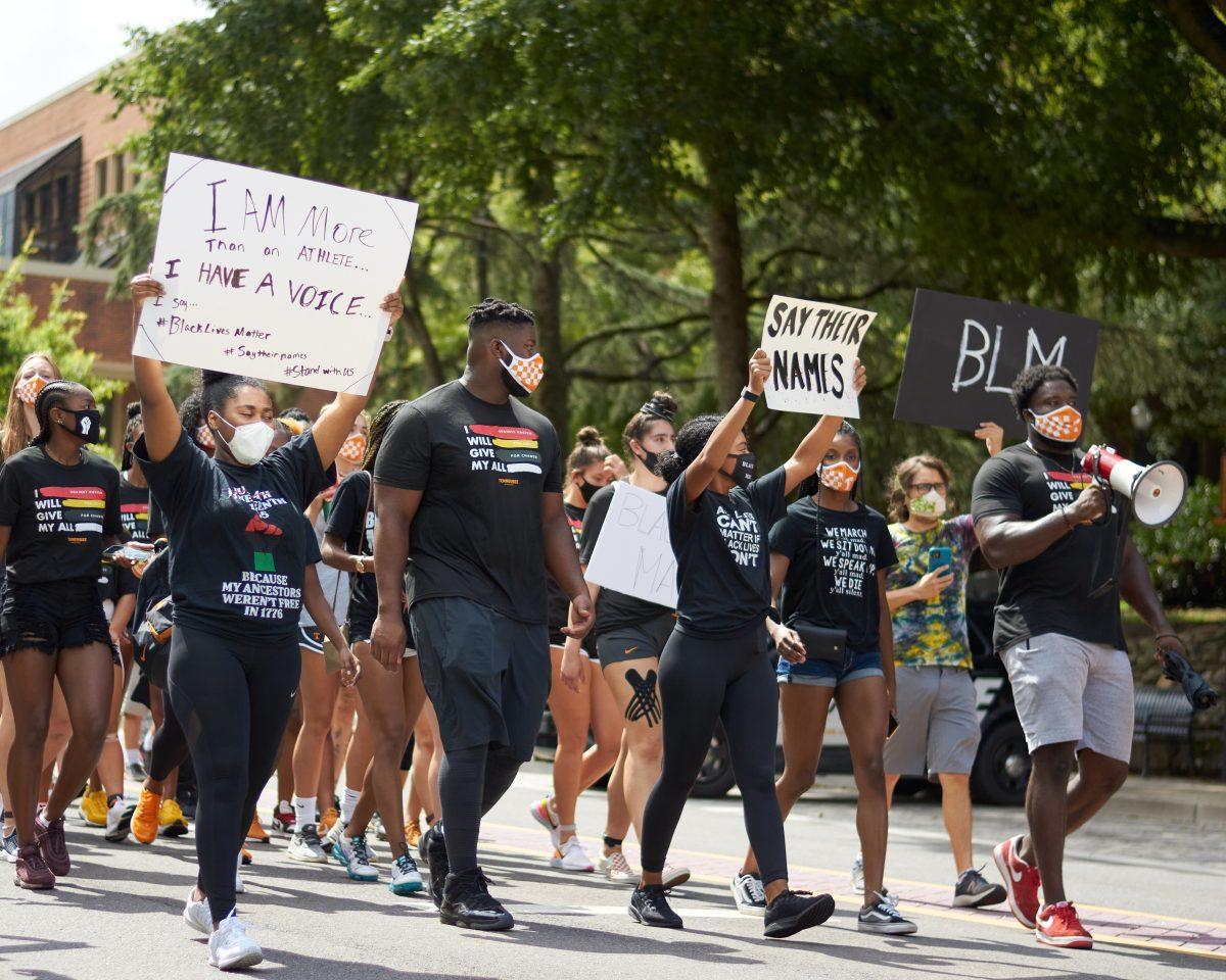A crowd of supporters march down Volunteer Boulevard during the BLM March on August 29, 2020.