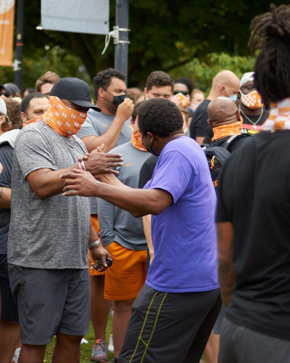 Two supporters greet each other in Circle Park while waiting for the BLM March to begin, on August 29, 2020.