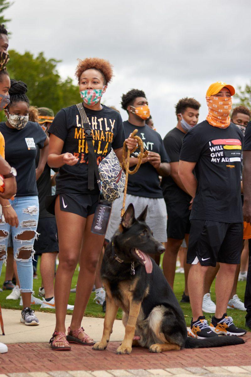A student waits with her dog in Circle Park until the BLM March begins, on August 29, 2020.