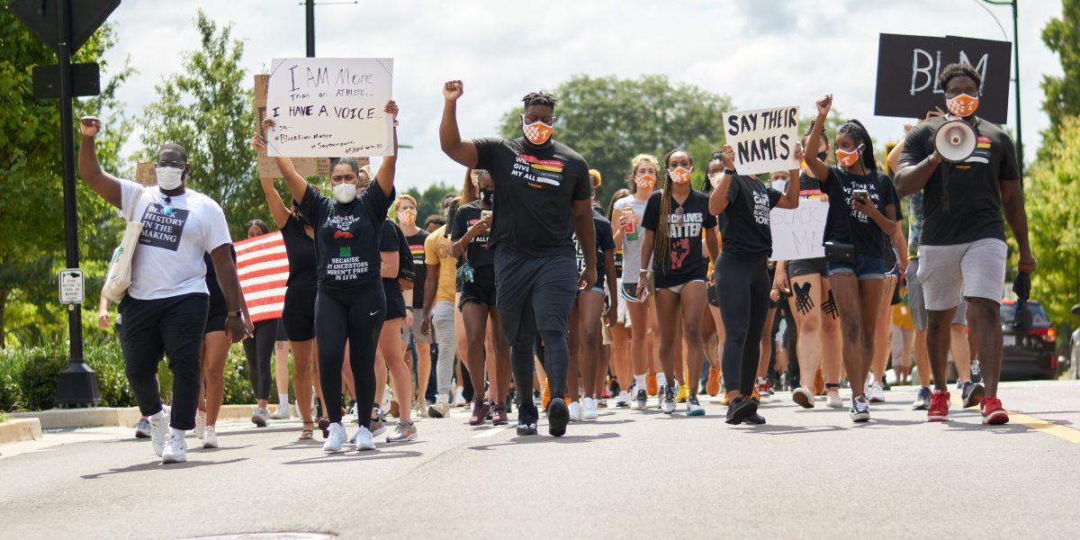 A crowd of supporters march down Volunteer Boulevard during the BLM March on August 29, 2020.
