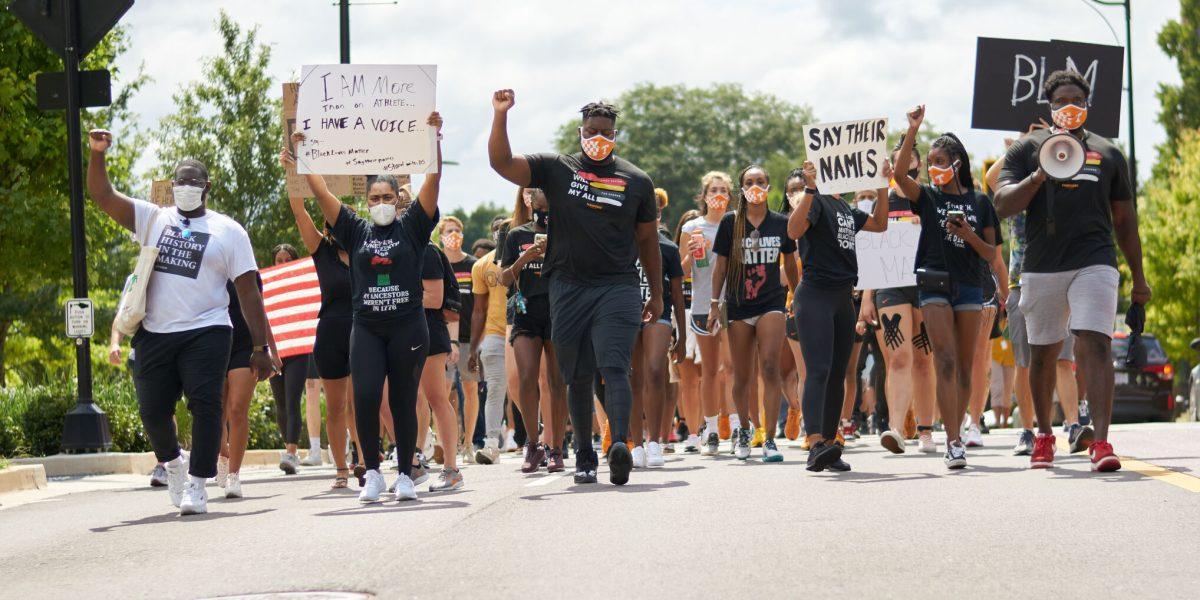 A crowd of supporters march down Volunteer Boulevard during the BLM March on August 29, 2020.