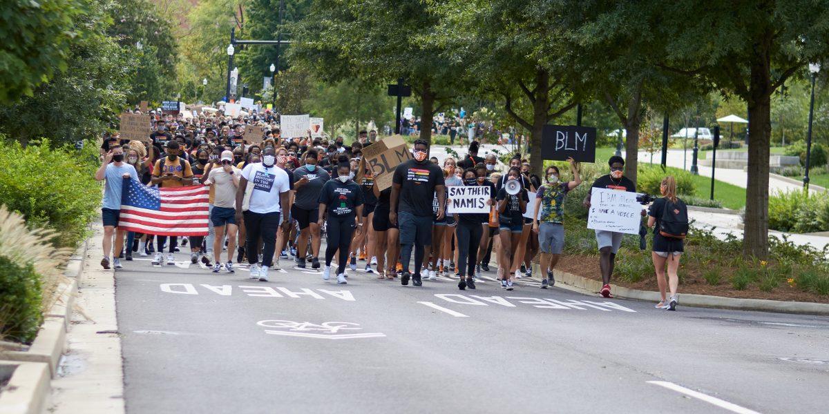 A crowd of supporters march down Volunteer Boulevard during the BLM March on August 29, 2020.
