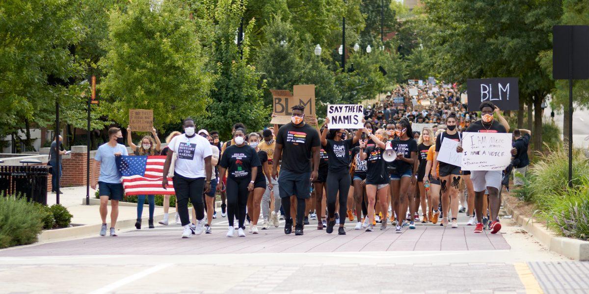 A crowd of supporters march down Volunteer Boulevard during the BLM March on August 29, 2020.