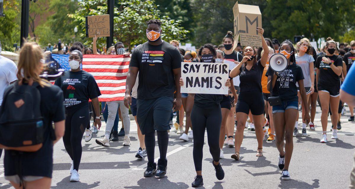 A crowd of supporters march down Volunteer Boulevard during the BLM March on August 29, 2020.
