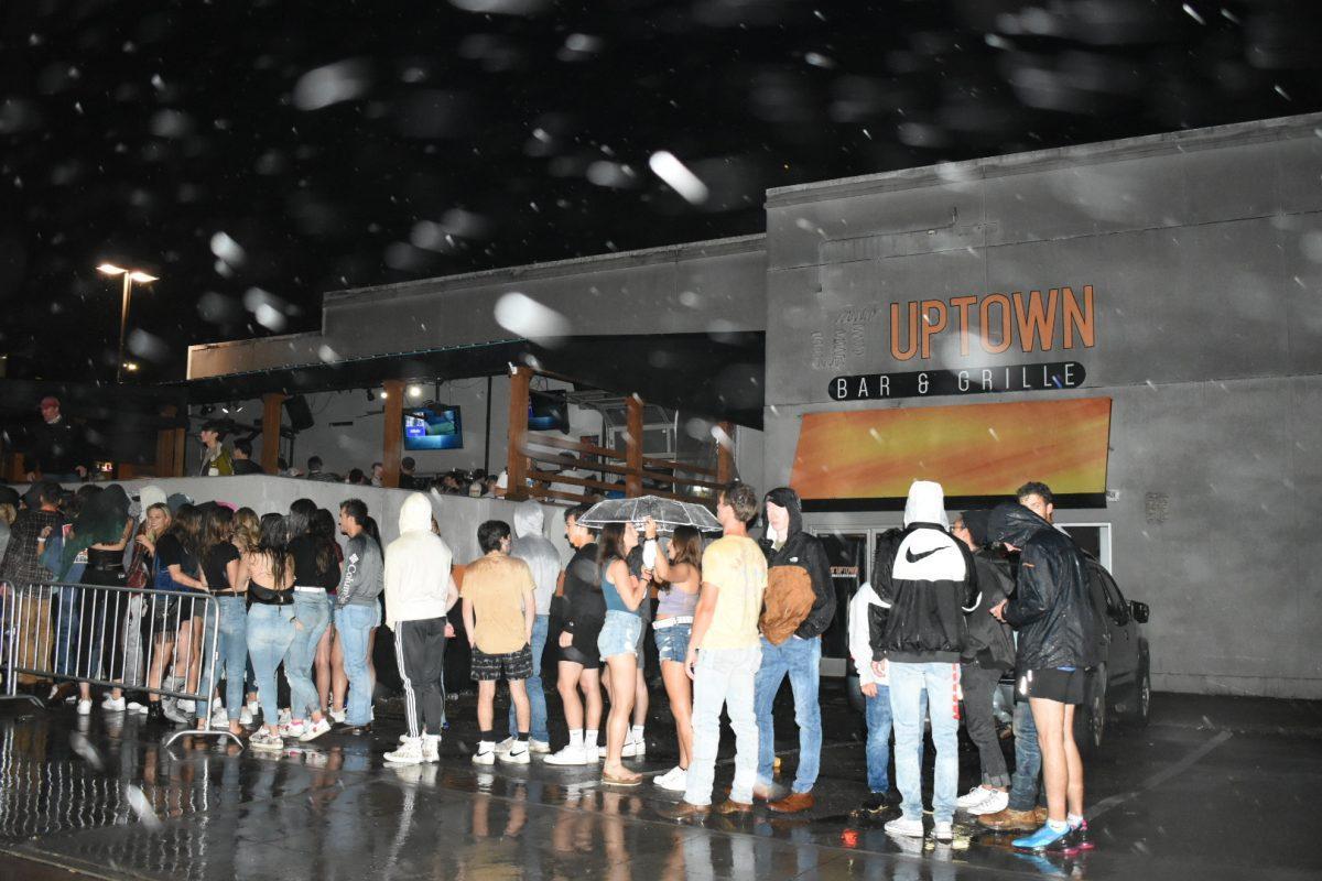 A crowd of students, none of them underage, wait outside a bar on the Strip. Friday, Sept. 25, 2020.