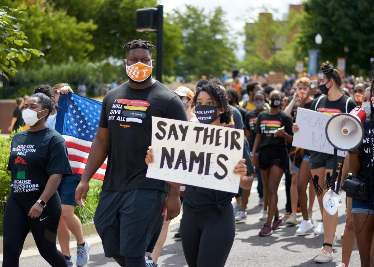 A crowd of supporters march down Volunteer Boulevard during the BLM March on August 29, 2020.